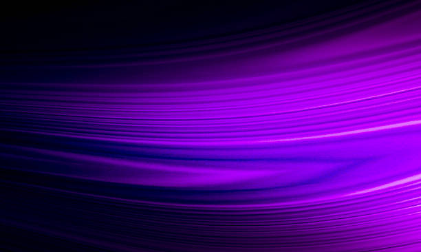 istock This abstract image features flowing purple and pink light waves on a dark blue background, resembling moving silk or liquid. It is suitable for a calm, mysterious, and luxurious background. 2232538229