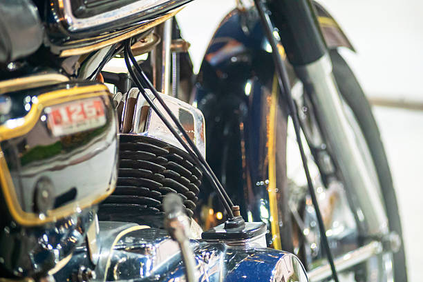 Front view of a weathered and rusty English vintage motorcycle isolated on a white background
