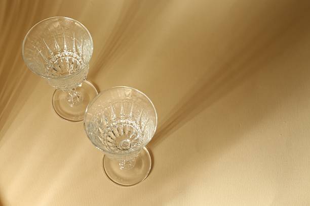 istock Two empty wine glasses on beige background, above view. Space for text 2232538837