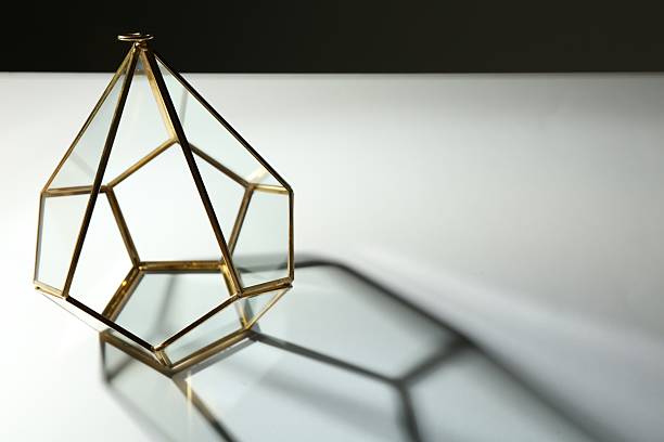 istock Stylish golden decor casting beautiful shadows on white table against black background, space for text 2232538869