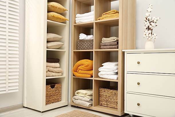 istock Home textile organization. Folded towels, blankets and pillows on shelving units indoors 2232539124