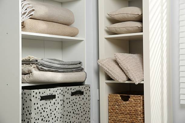 istock Home textile organization. Folded blankets and pillows on shelving units indoors, closeup 2232539130
