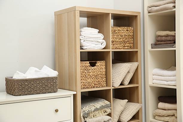 istock Home textile organization. Folded towels, blankets and pillows on shelving units indoors 2232539147