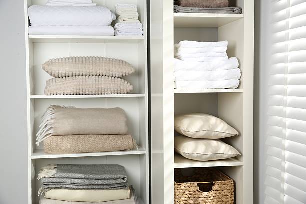 istock Home textile organization. Folded towels, blankets and pillows on shelving units indoors, closeup 2232539149
