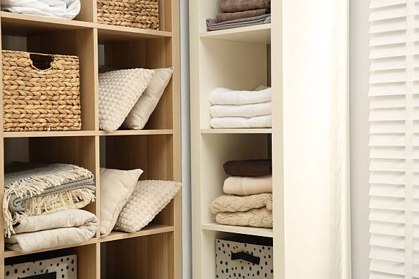 istock Home textile organization. Folded towels, blankets and pillows on shelving units indoors, closeup 2232539158
