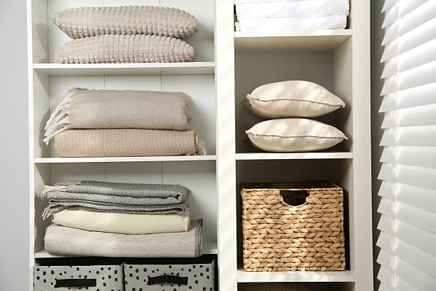 istock Home textile organization. Folded towels, blankets and pillows on shelving unit indoors, closeup 2232539161