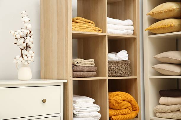 istock Home textile organization. Folded towels, blankets and pillows on shelving units indoors 2232539181