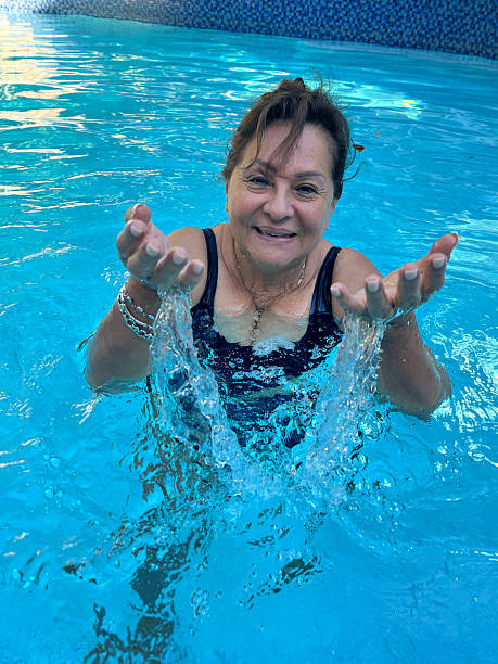 istock Attractive Hispanic senior woman in pool 2232539872
