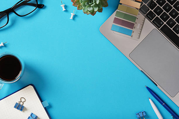 istock Workspace background with laptop, coffee, glasses, and stationery. Space for your text. 2232541213