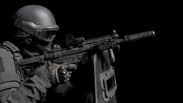 istock soldier dressed in tactical attire is aiming a rifle with focus and precision, showcasing training or mission readiness under low light conditions. 3d render 2232542919