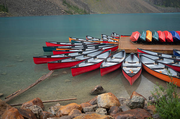 istock Canoes lined up on dock at mountain lake Canada 2232549888