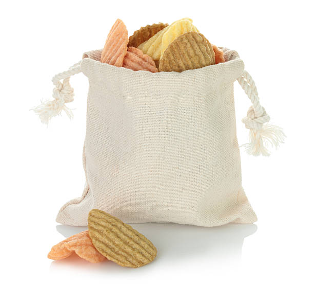 istock Open cotton fabric bag filled with assorted vegetable chips isolated on transparent background. Eco friendly zero waste packaging for healthy vegan and organic snack food. Full focus photo 2232549971