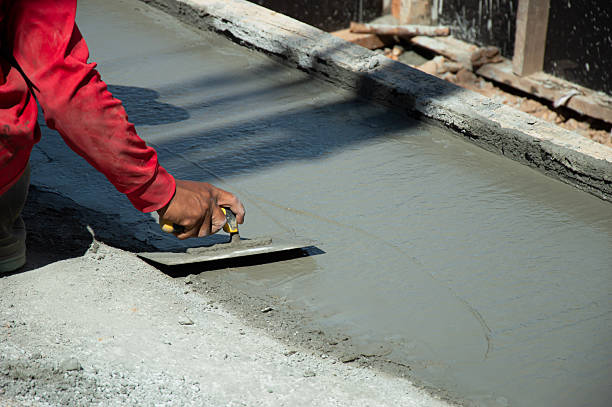 istock Workers are leveling the floor after pouring concrete. 2232552398