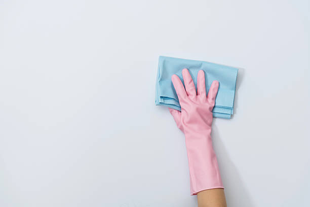istock Woman hand cleaning white wall with rag 2232554139