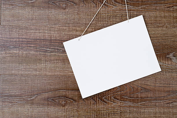 istock White blank poster hanging on the wall 2232554362