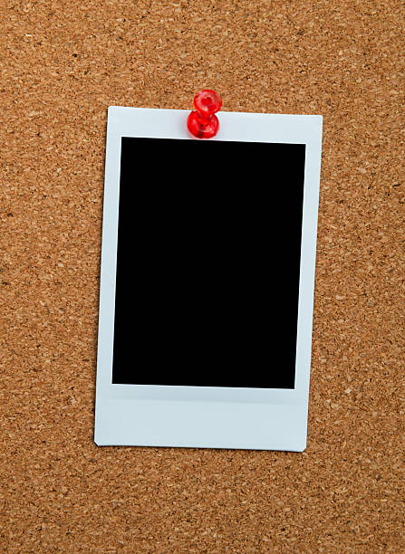 istock Single blank instant print pictures attached on cork board with copy space 2232554458