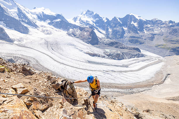 istock Man Ascending a Rocky Via Ferrata with Glacier Backdrop 2232555333