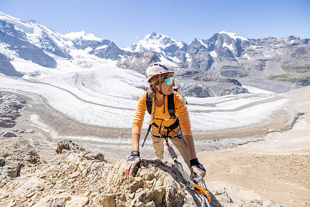 istock Woman Climbing Rocky Mountain with Glacier View 2232555552