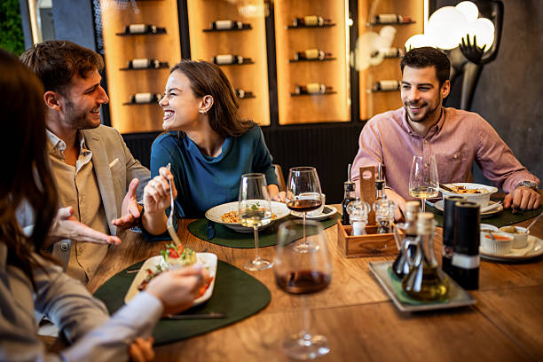 istock Colleagues Having Fun Sharing Lunch at Restaurant 2232555612