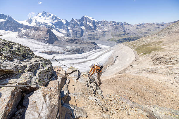 istock Woman Climbing Rocky Mountain Trail with Glacier View 2232555737