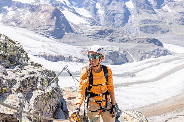 istock Woman Climbing Rocky Mountain Trail with Glacier View 2232555801