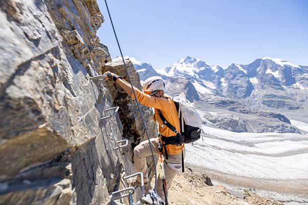 istock Woman Climbing Mountain via Ferrata Route 2232556158