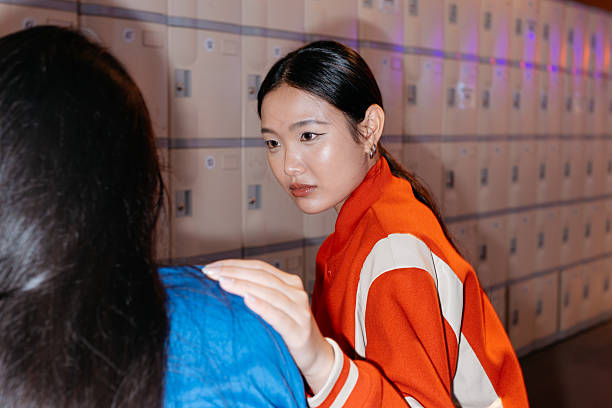 istock Young Asian Women Interacting in Locker Room 2232556905