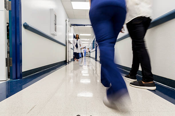 Cropped shot of a medical team walking through their hospital corridor