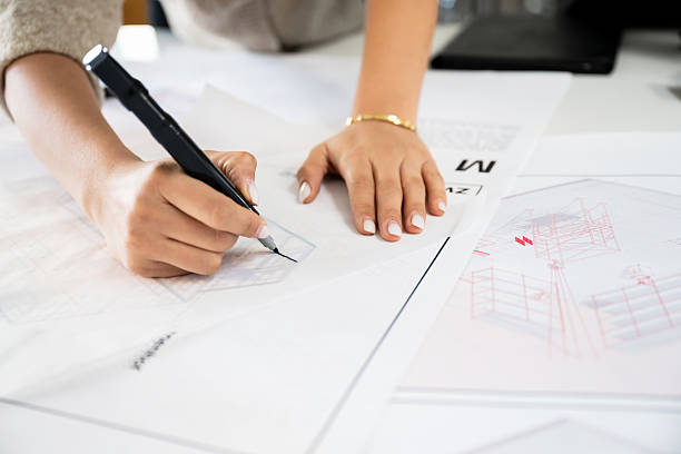 istock Close-up of student working with architectural drawing and precision tools 2232558492