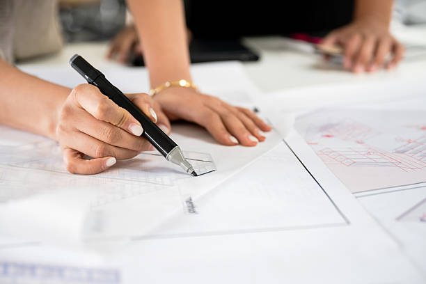 istock Close-up of student sketching architectural drawing under teacher’s supervision 2232558493