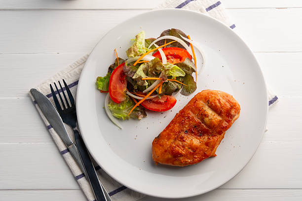 Grilled chicken steak and vegetables. Close up.