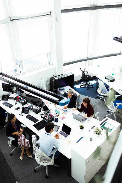 istock Business people working together in modern open plan office 2232560989