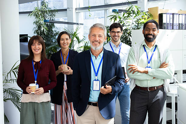 istock Business team smiling at camera wearing badges in office 2232561057