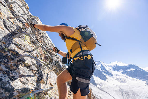 istock Climber on a Rocky Via Ferrata with Glacier Views 2232563600