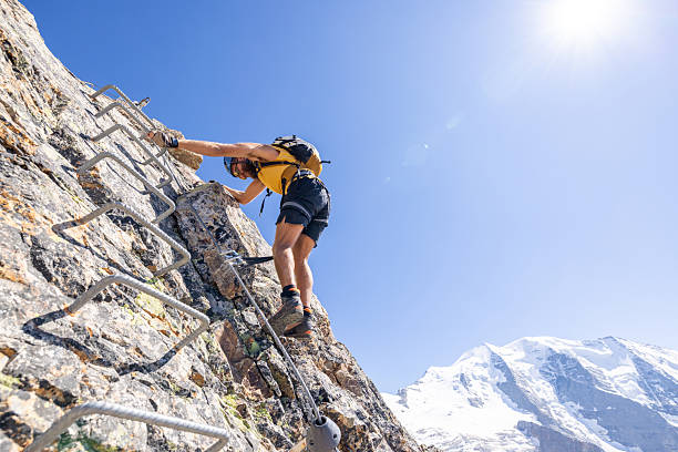 istock Man Climbing Rocky Mountain with Safety Gear 2232563747