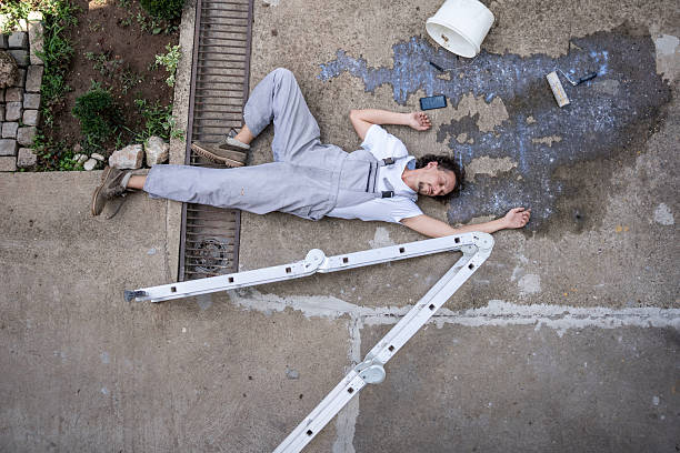istock Worker Lying on Ground After Accident with Collapsed Ladder Outdoors 2232565315