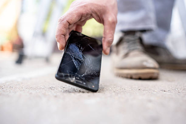 istock Close-Up of Broken Smartphone Being Picked Up From the Ground 2232565553