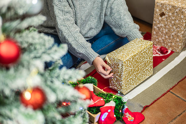 istock Christmas gifts on the floor next to the tree 2232565604