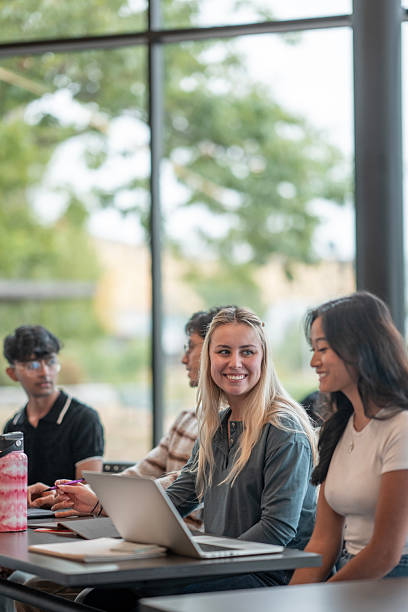 istock Diverse Group of Students Collaborating on Laptop in Bright Classroom Setting 2232565826