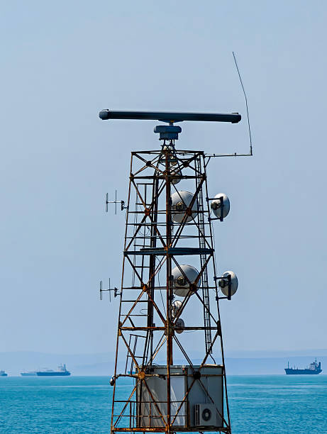 istock Coastal Marine Radar Tower with Communication Antennas and Cargo Ships. Maritime Navigation and Surveillance Infrastructure Concept 2232566272