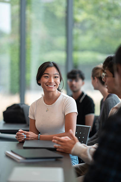 istock Young Woman Engaging in a Collaborative Discussion in a Bright Modern Setting 2232568004