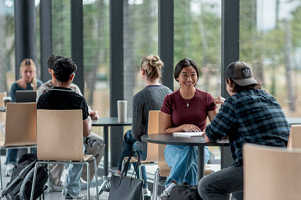 istock Group of Students Socializing and Studying Together in a Modern Campus Setting 2232572880