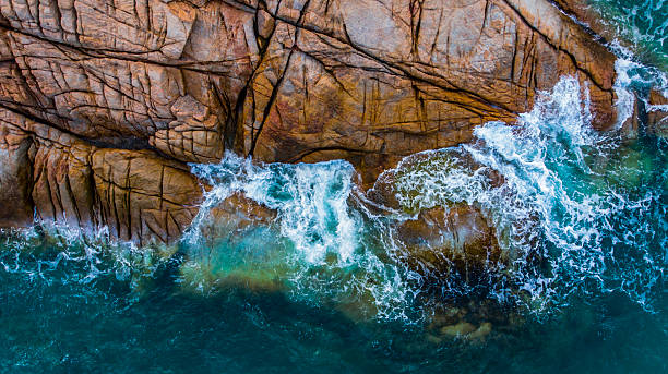 istock Turquoise sea laps a rugged, rocky coastline 2232573166