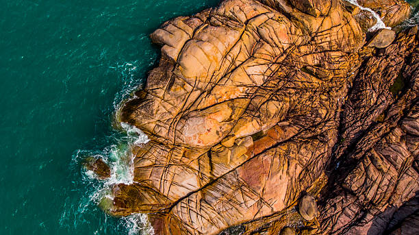 istock Turquoise sea laps a rugged, rocky coastline 2232573207