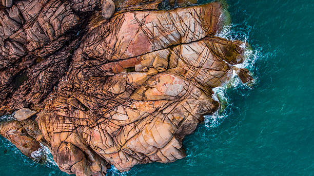 istock Turquoise sea laps a rugged, rocky coastline 2232573230