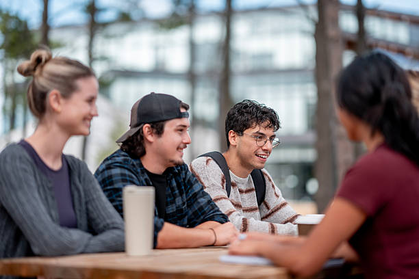 istock Diverse Group of Young Adults Engaging in Outdoor Conversation 2232573524