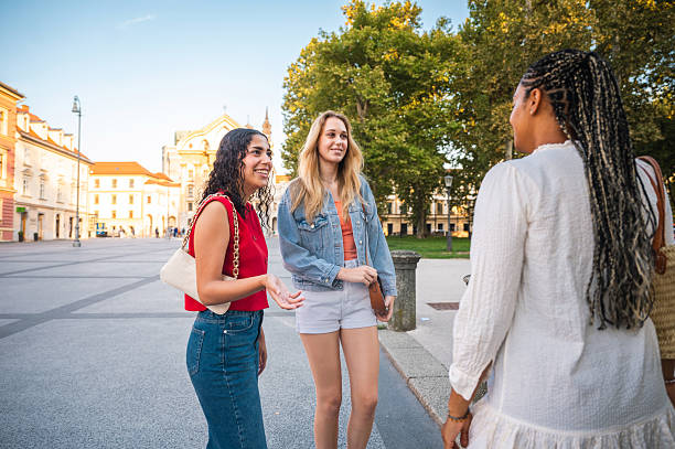 istock Young Diverse Women Engaging in Lively City Conversation 2232573602