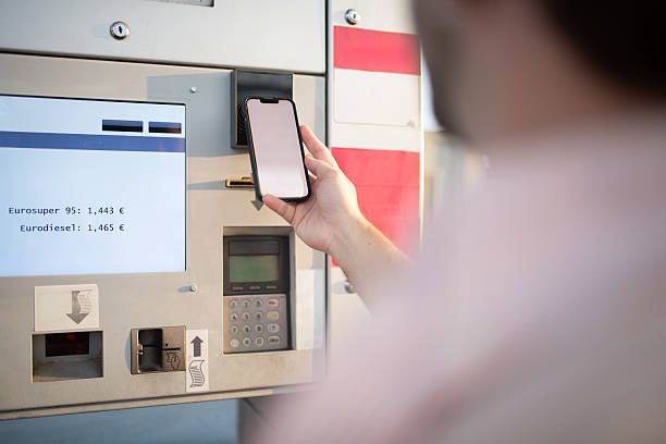 istock Young Hispanic Using Smartphone for Contactless Payment at Gas Station 2232574009