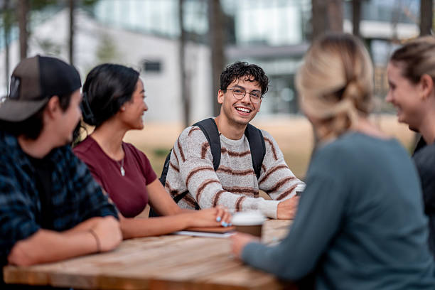 istock Happy Group of Diverse Students Enjoying Conversation at Outdoor Campus Table 2232574046