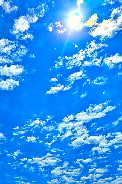 Scattered altocumulus clouds in a blue sky over southern Maryland